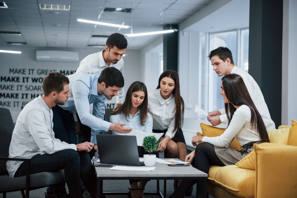 guy shows document girl group-young-freelancers office have conversation working